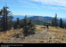 A group of mountain bikers rides along the Seven Summits trail on Record Ridge
